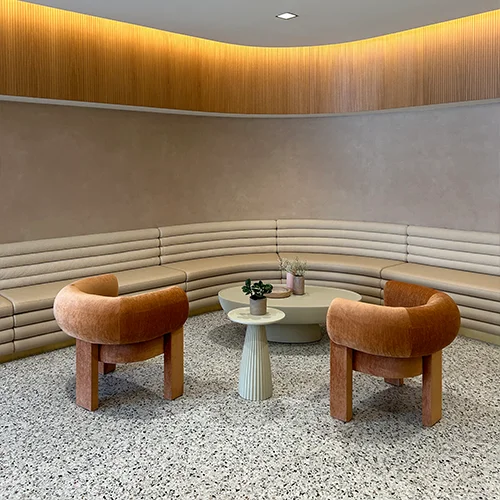 SKIN clinic Winnipeg waiting area. With beautiful brown chair set and table.